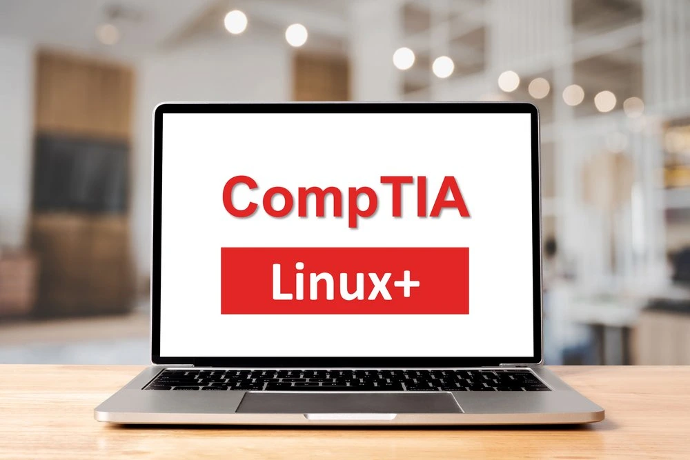Image of laptop displaying an image containing the words CompTIA Linux+