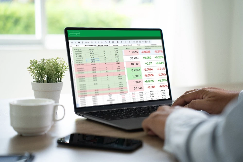 A photo of a person using Microsoft Excel on a laptop