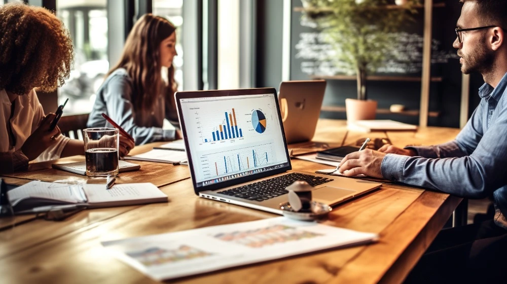 People sat around a desk using Microsoft Power BI