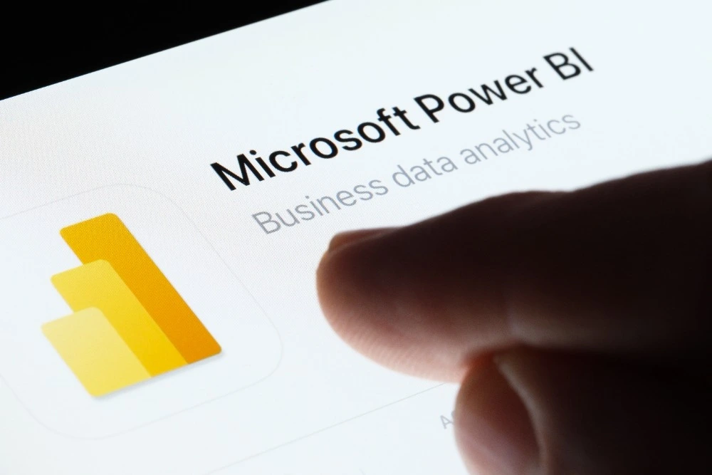 An image of a person pointing at the Microsoft Power BI app