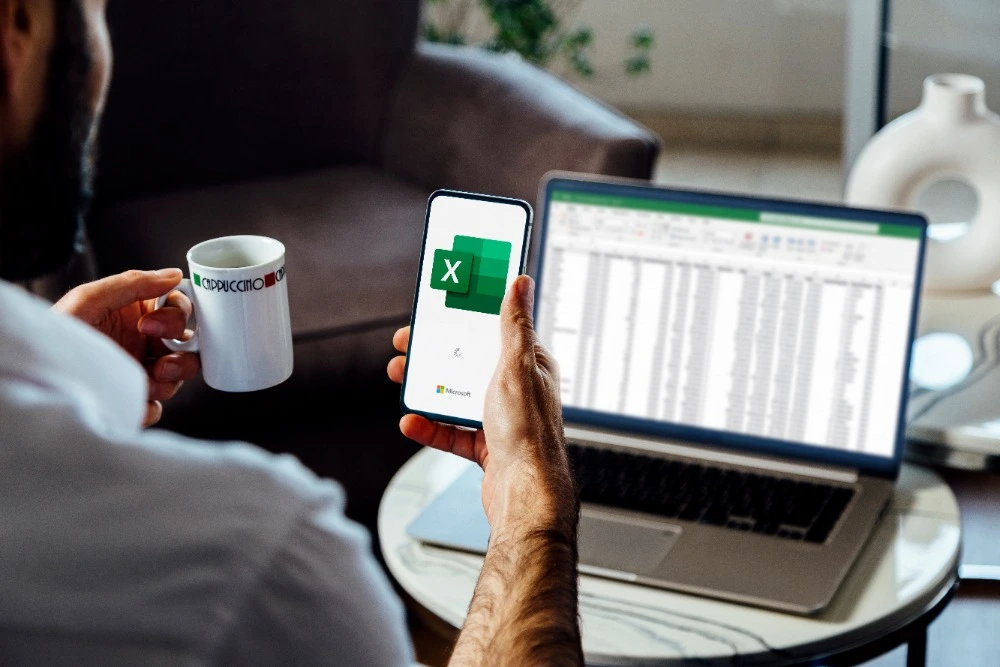 A man using Microsoft Excel on a laptop