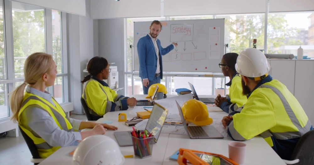 Construction site supervisor welcoming and inducting a new employee
