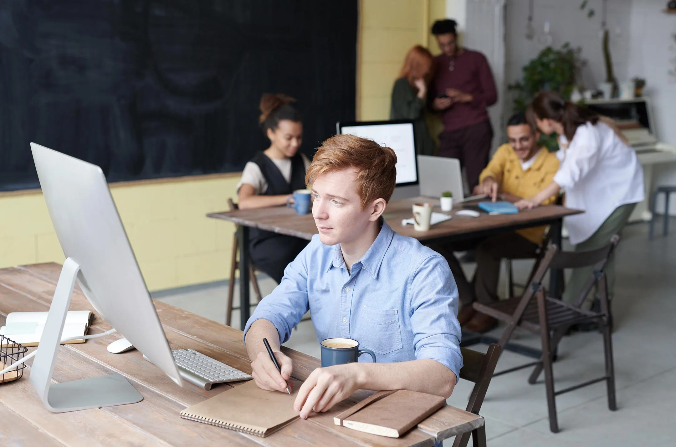 Professional analysing spreadsheet data on a laptop