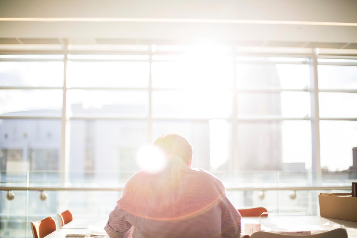 Professional working with data at a computer in a bright office