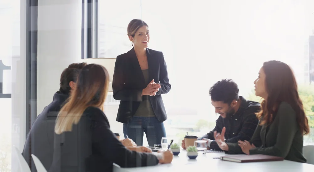 Professional woman communicating confidently with colleagues during a workplace training session