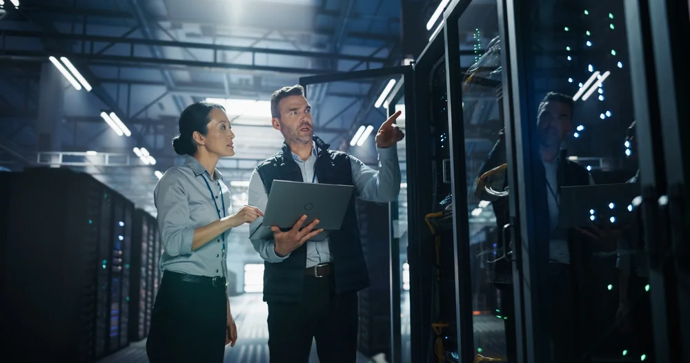 Data centre professionals inspecting server infrastructure in a modern facility