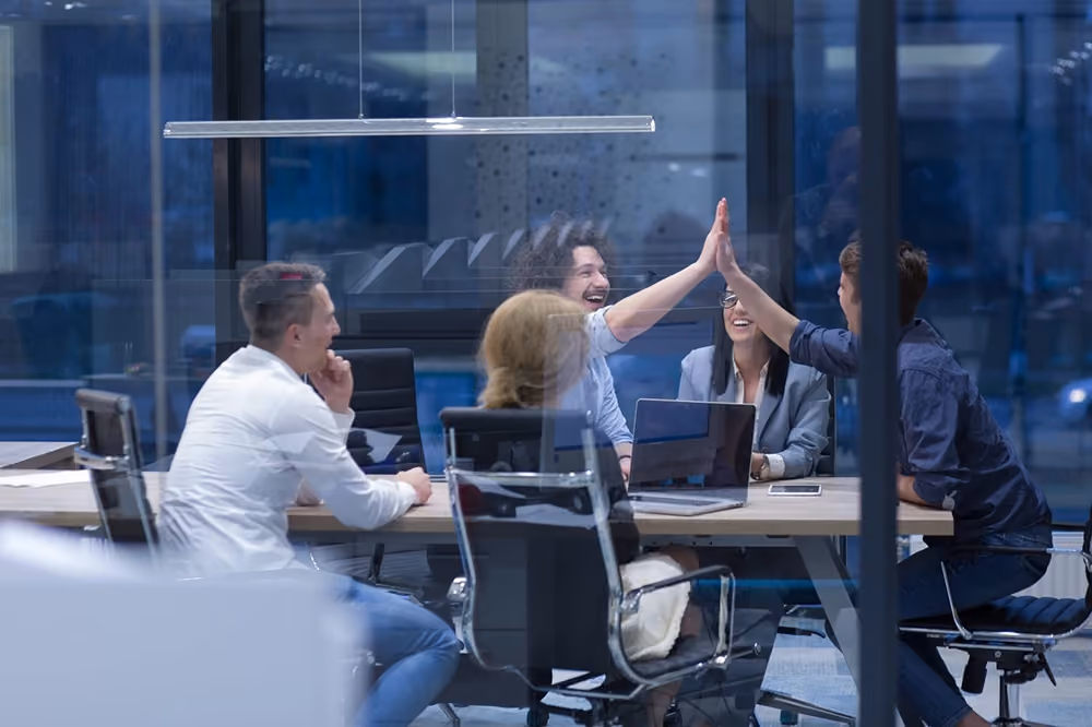 Imagem de um grupo de colegas de trabalho felizes conversando sobre Crédito B2B.