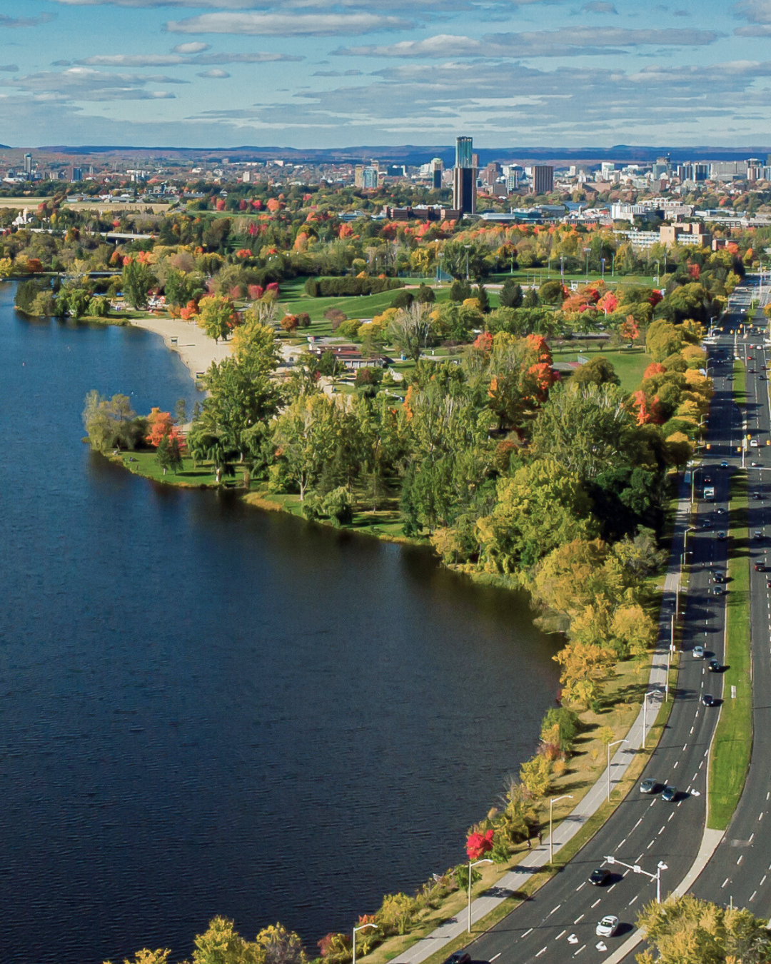A woman and a man blurred in the background, holding keys in the foreground.