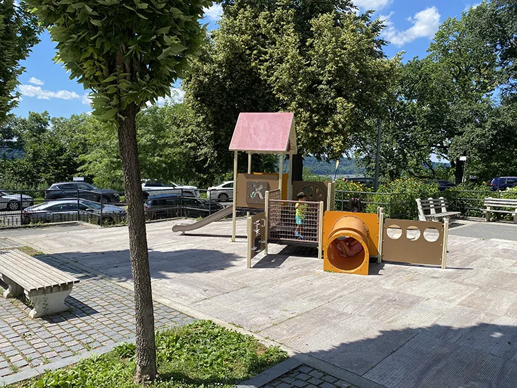 the tots playground has a house and tunnel but still very hot