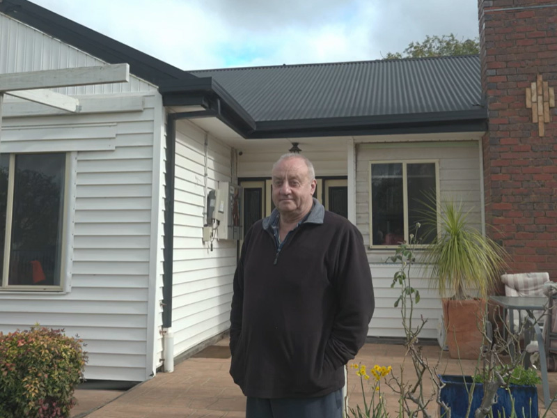 CALC client Rick standing in front of his home