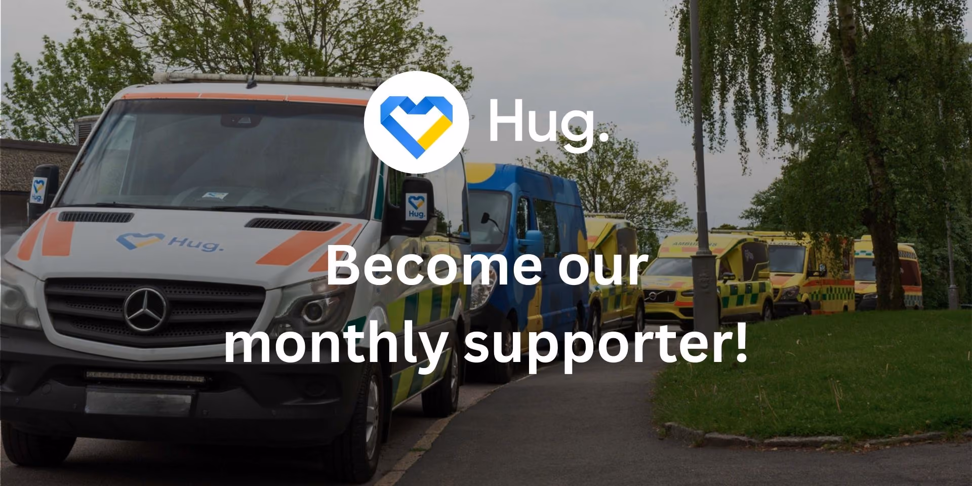 Line of ambulances parked along a road with text overlay reading 'Hug. Become our monthly supporter!'