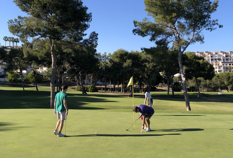 Golfers putting on the green