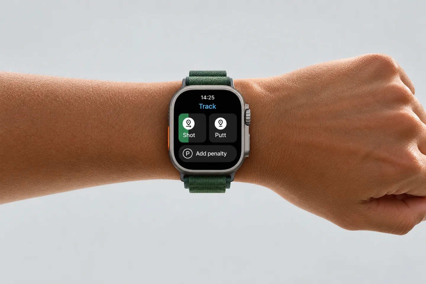A smartwatch on a golfer's wrist showing the Golf Pad Track screen with Shot, Putt and Add penalty buttons