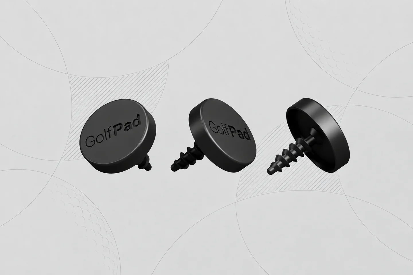Three black Golf Pad TAGS trackers with screw-in posts that fit into the end of a golf grip