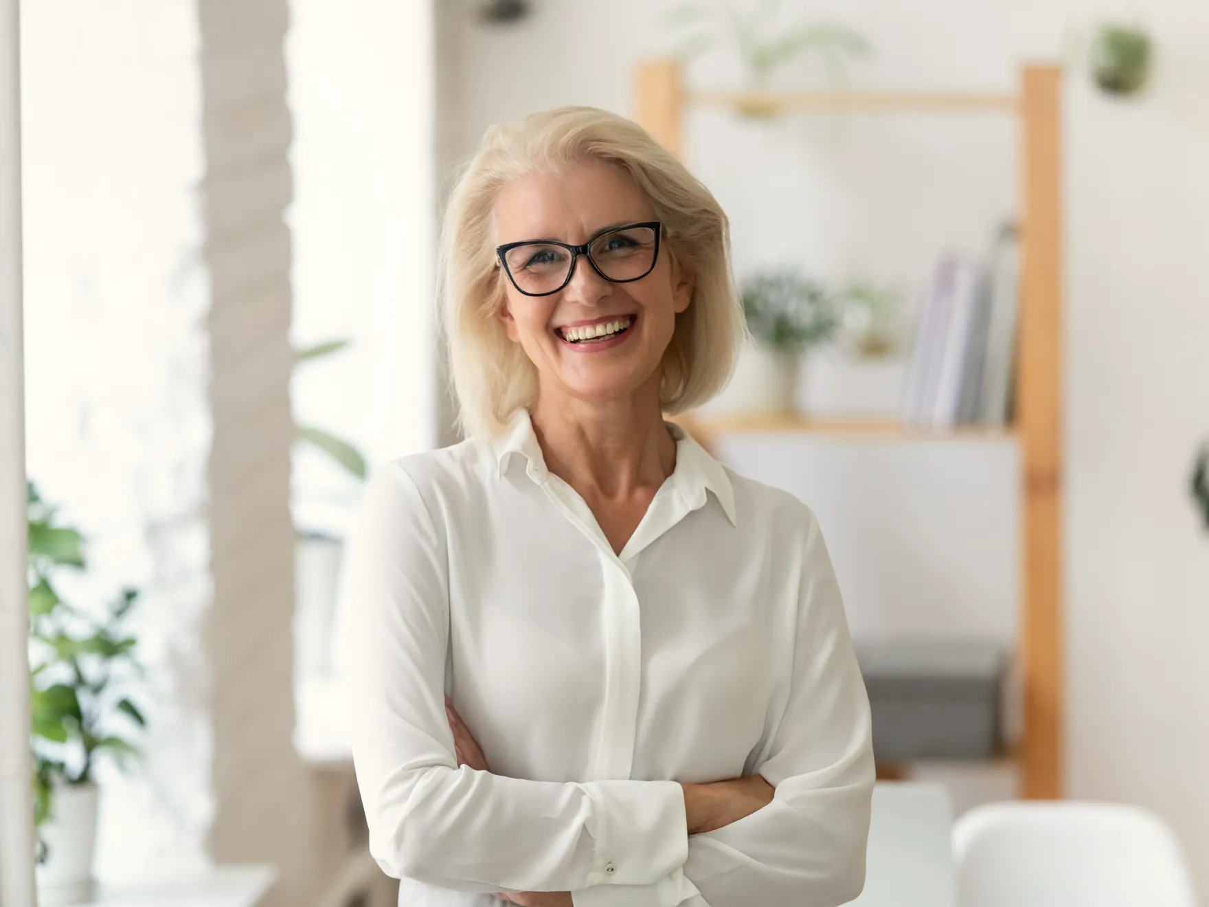 a woman in a white shirt and black glasses