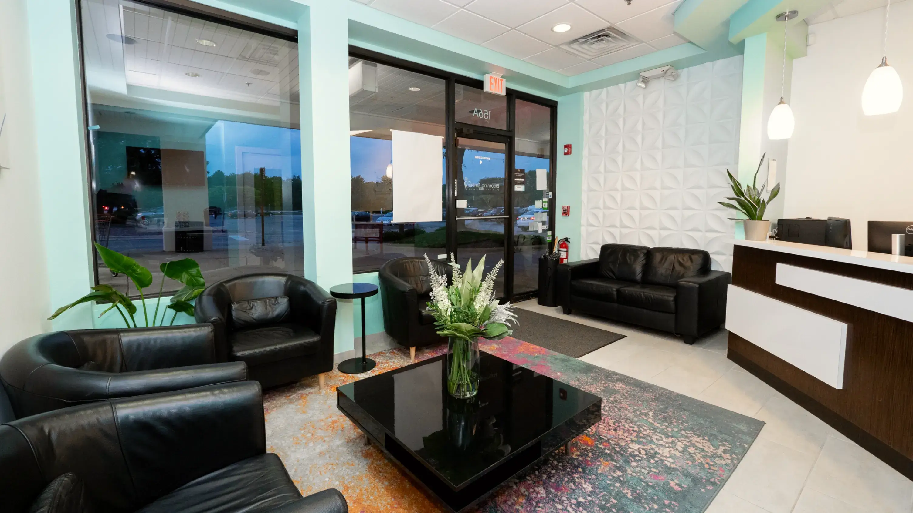 a room with two black leather chairs and a black coffee table