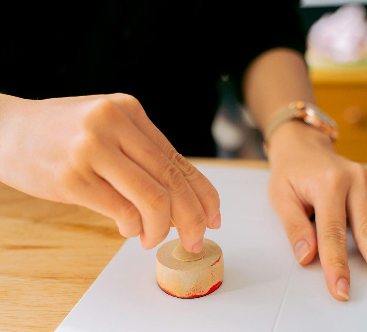 Person stamping paper