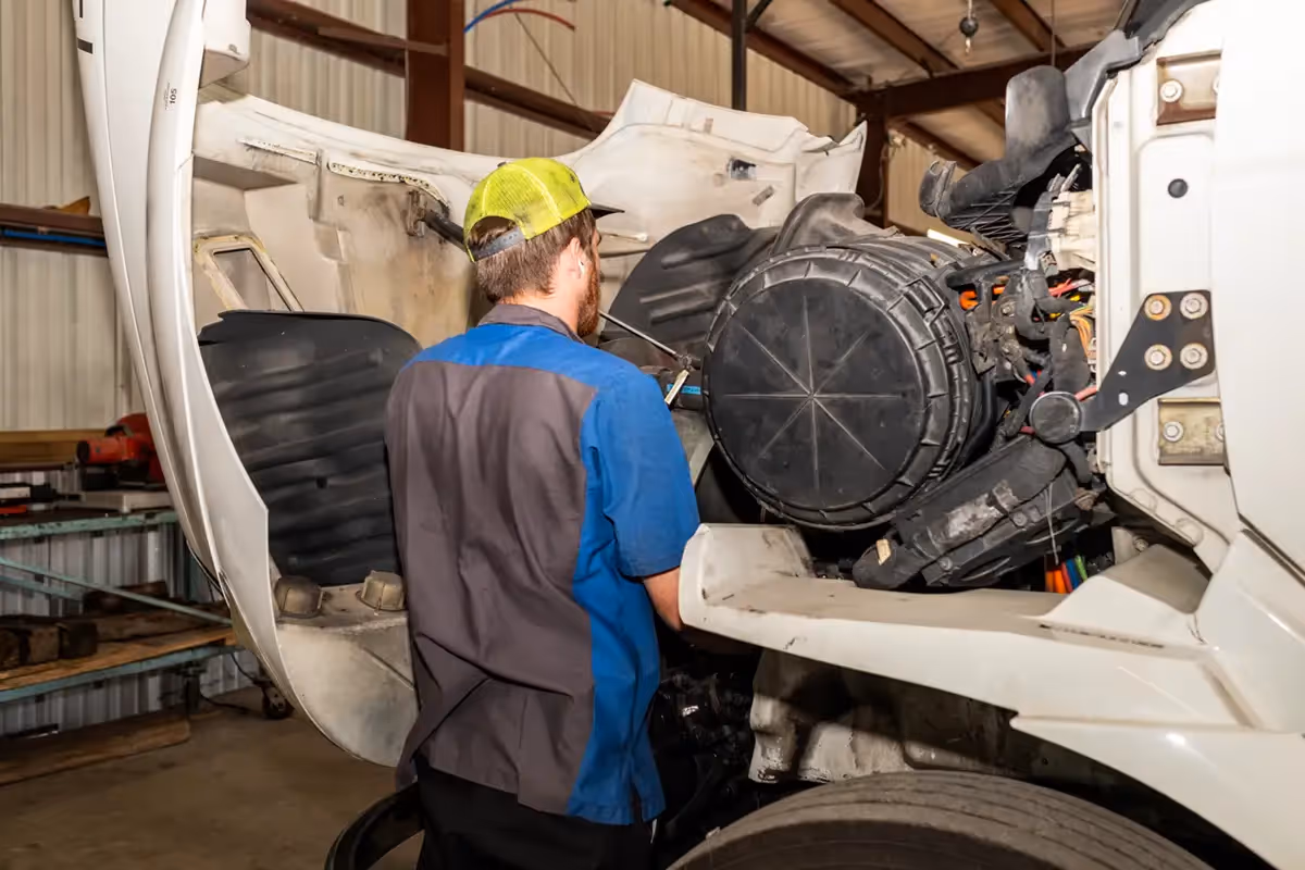 Diesel mechanic performing preventive maintenance services on semi-truck in Clearwater, Florida