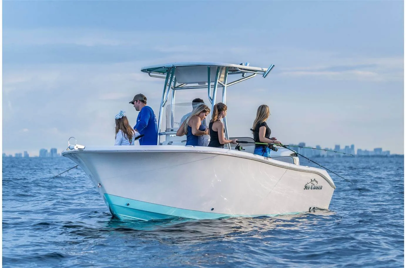 Open bow center console boat with dual engines driving in the beautiful teal salt water