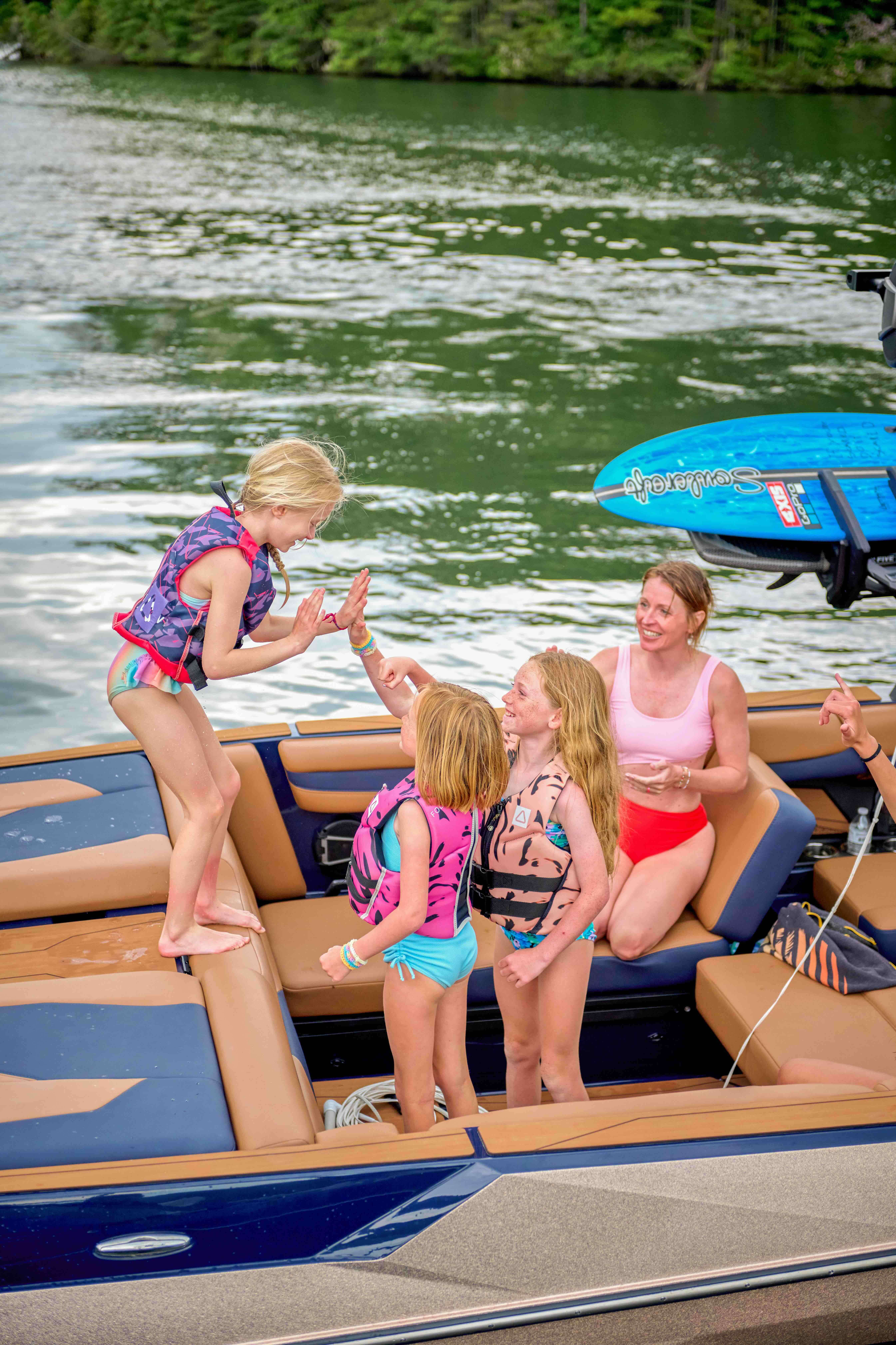 mastercraft boats pulling up to let kids high five each other and say hello
