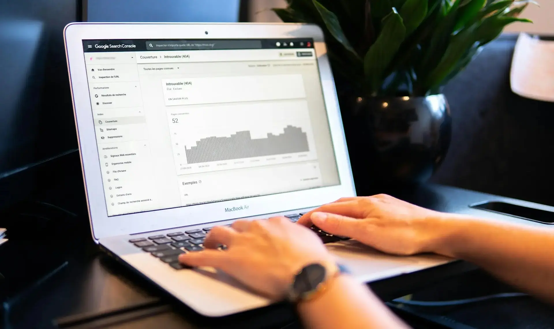 Person at office desk looks at Google Search Console screen