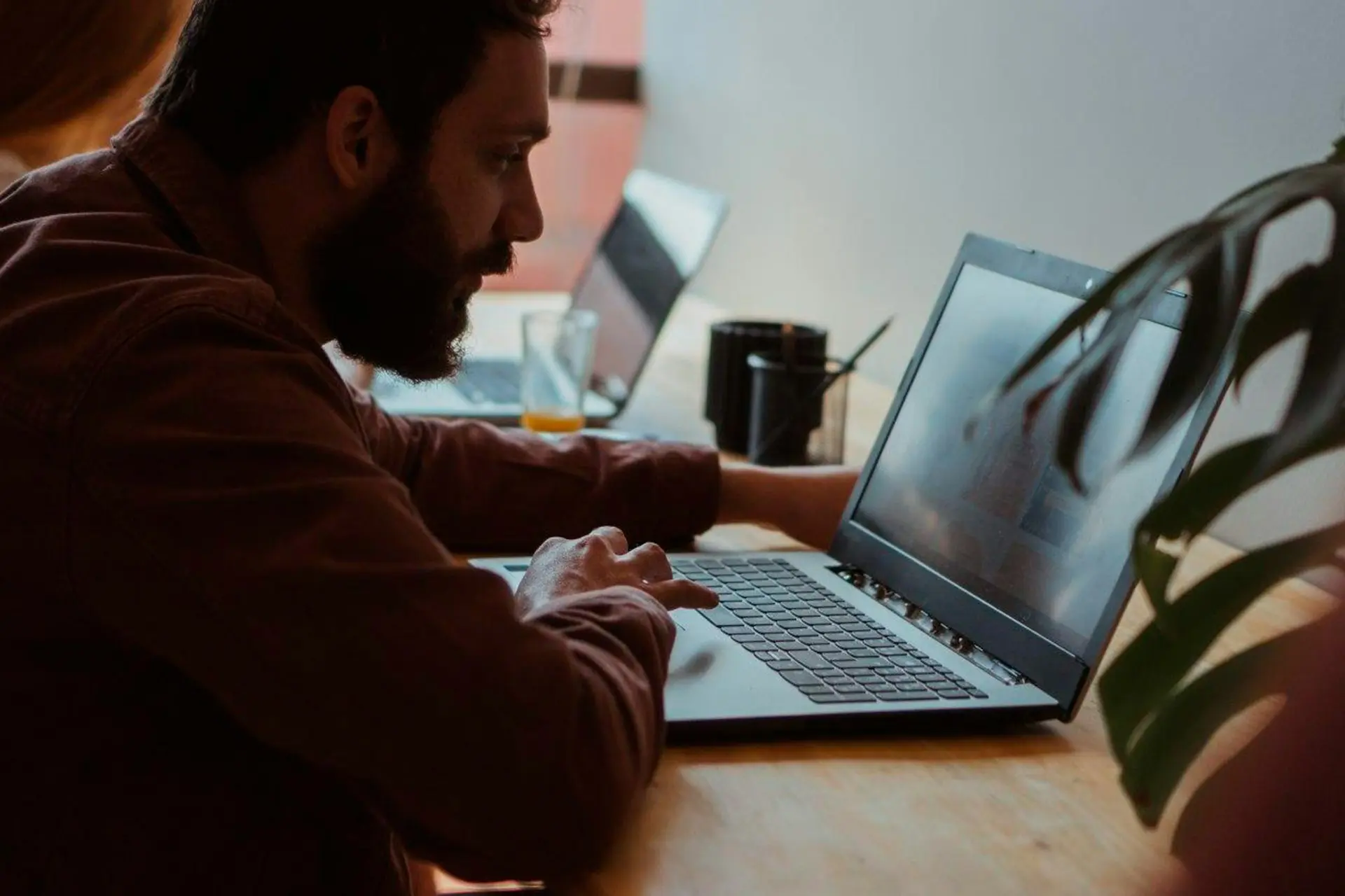 Man studying document at the laptop screen in office