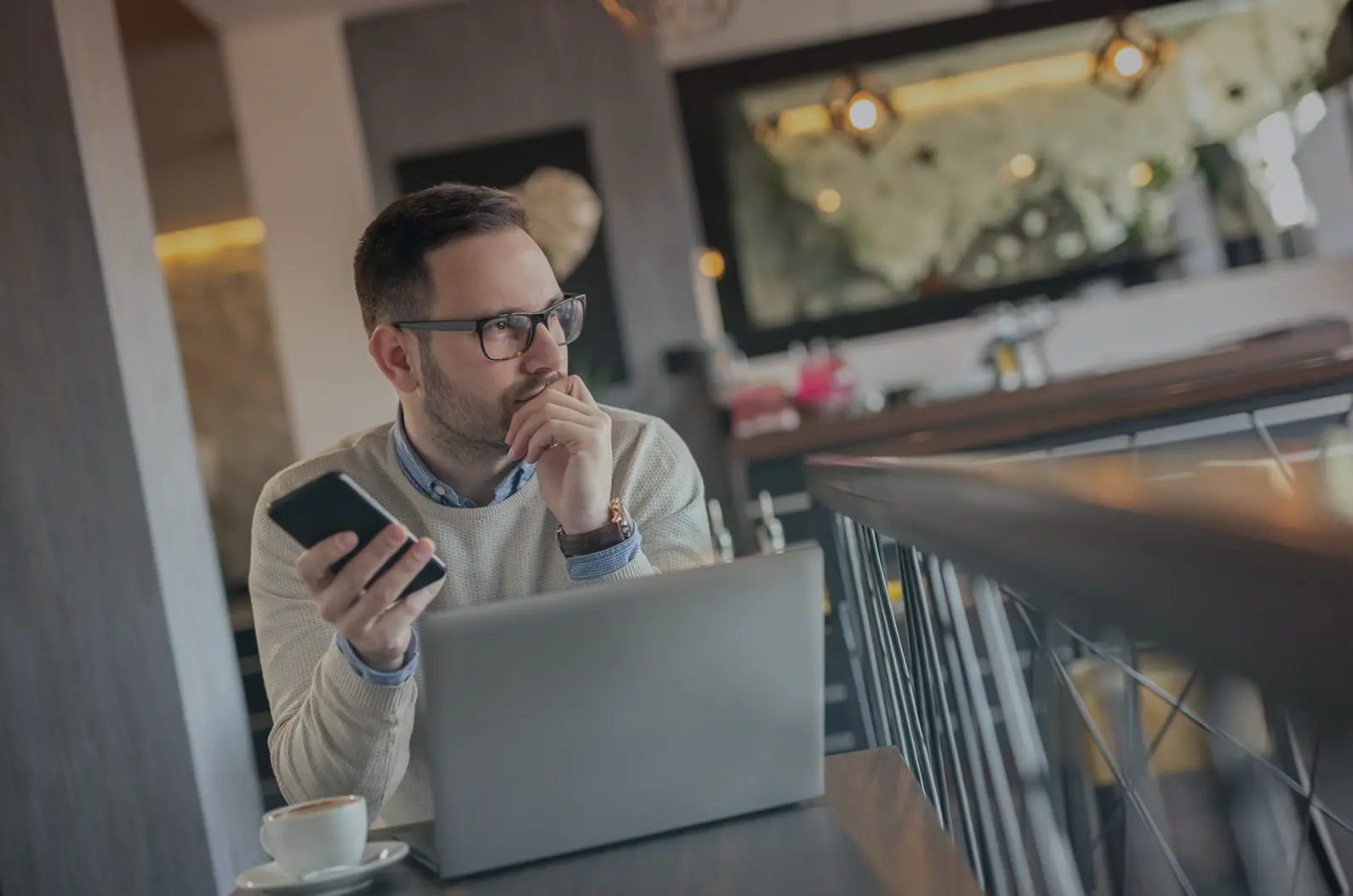Businessman working with laptop and thinking over decision