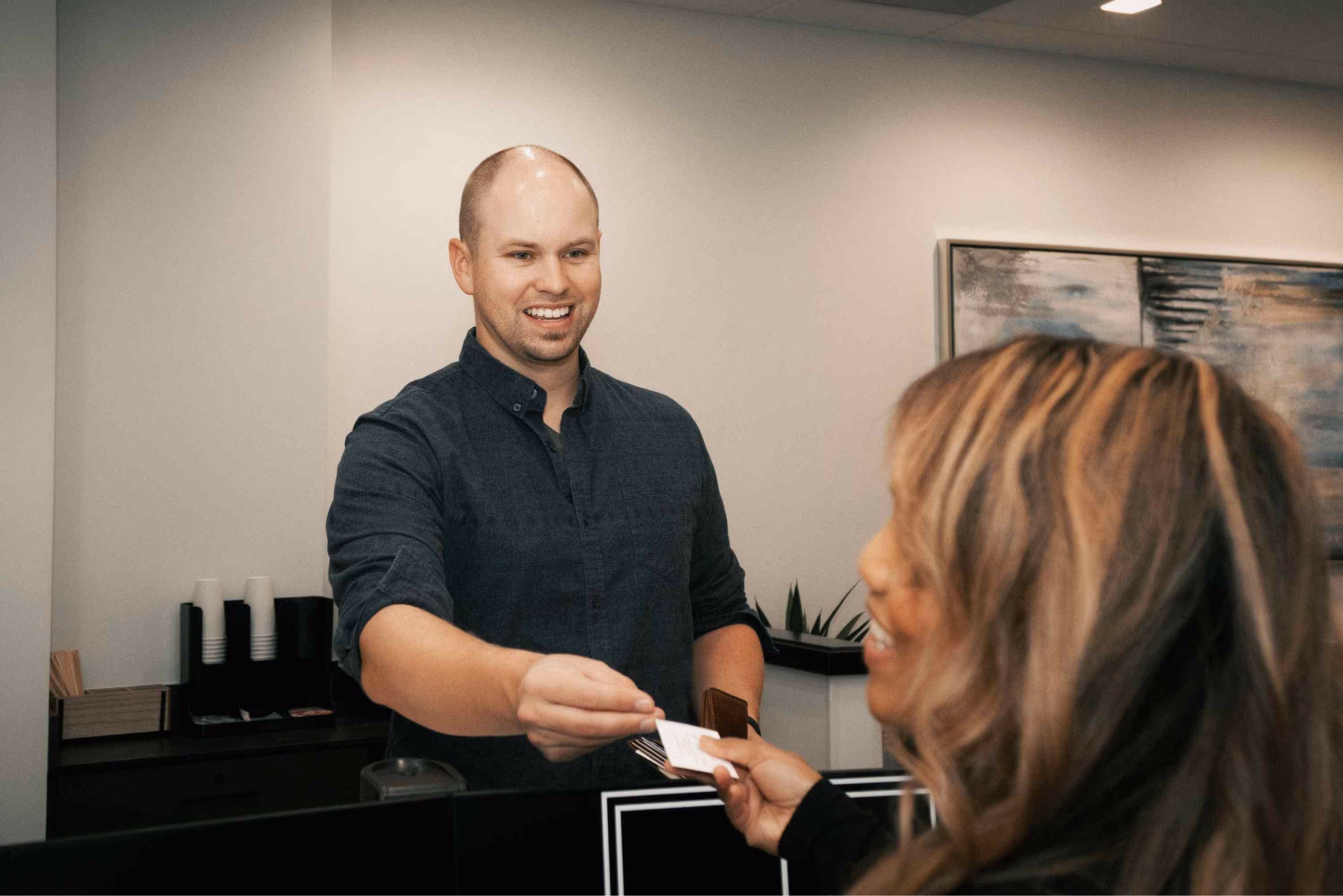 Photo of a team member handing a patient some information