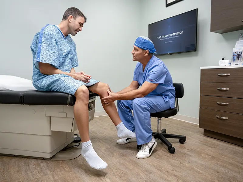 Orthopedic surgeon and assistants performing surgery