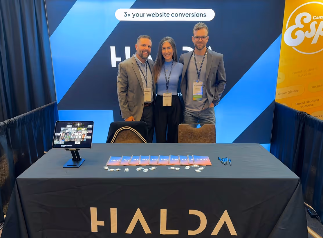 Halda team members at a branded booth during a networking event