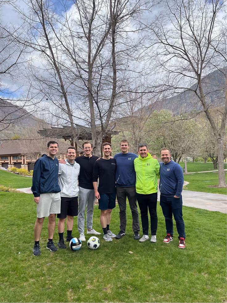 Halda team group photo on a grassy field during a team outing