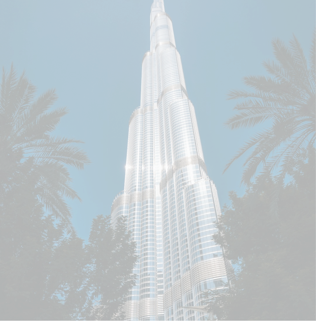 Full-height architectural image of a modern skyscraper with surrounding foliage.