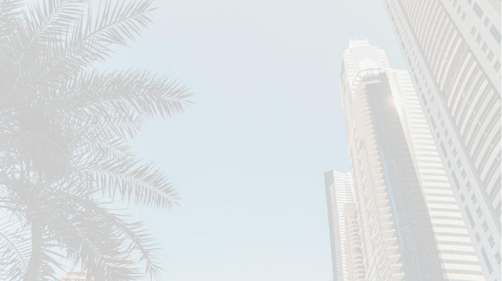 Close-up architectural view of a modern skyscraper's upper section and surrounding trees.
