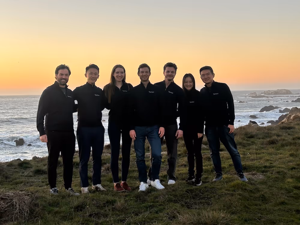 A group photo of the Centari team at the beach.