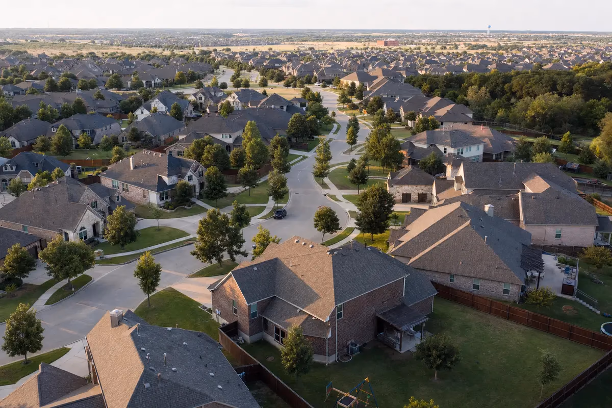 Aerial view of a master-planned Cedar Park neighborhood with rows of suburban homes and tree-lined streets.