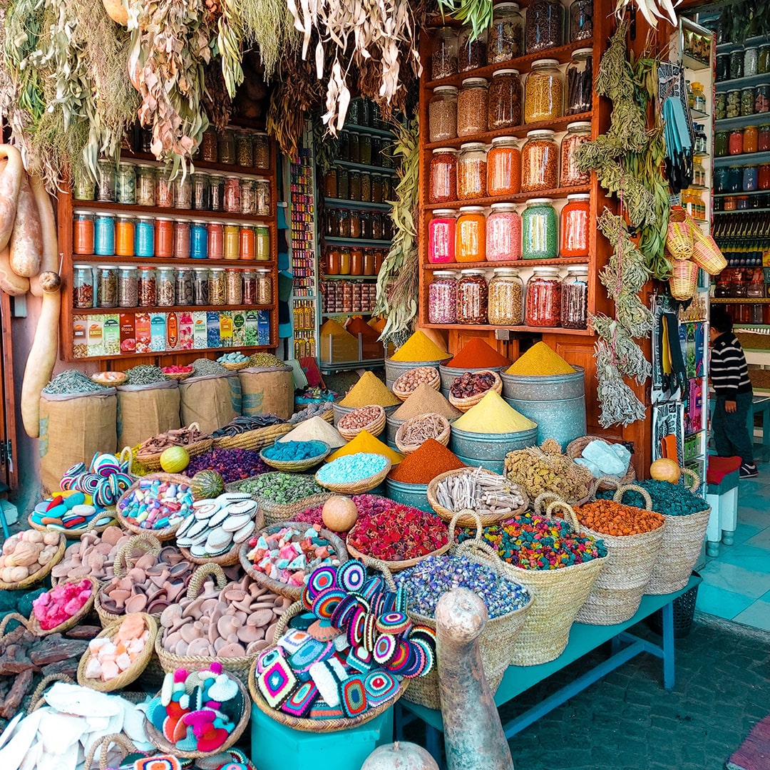 image of a moroccan store with colorful displays of spices and foods in baskets