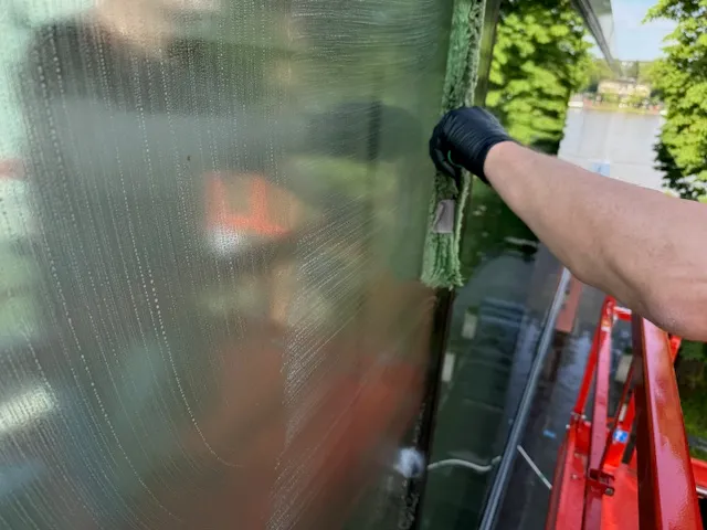 Reinigung einer Glasfassade, Wintergarten, Glasdach mit einem Hublift, Arbeiitsbühne. Wintergartenreinigung Lieven Services.