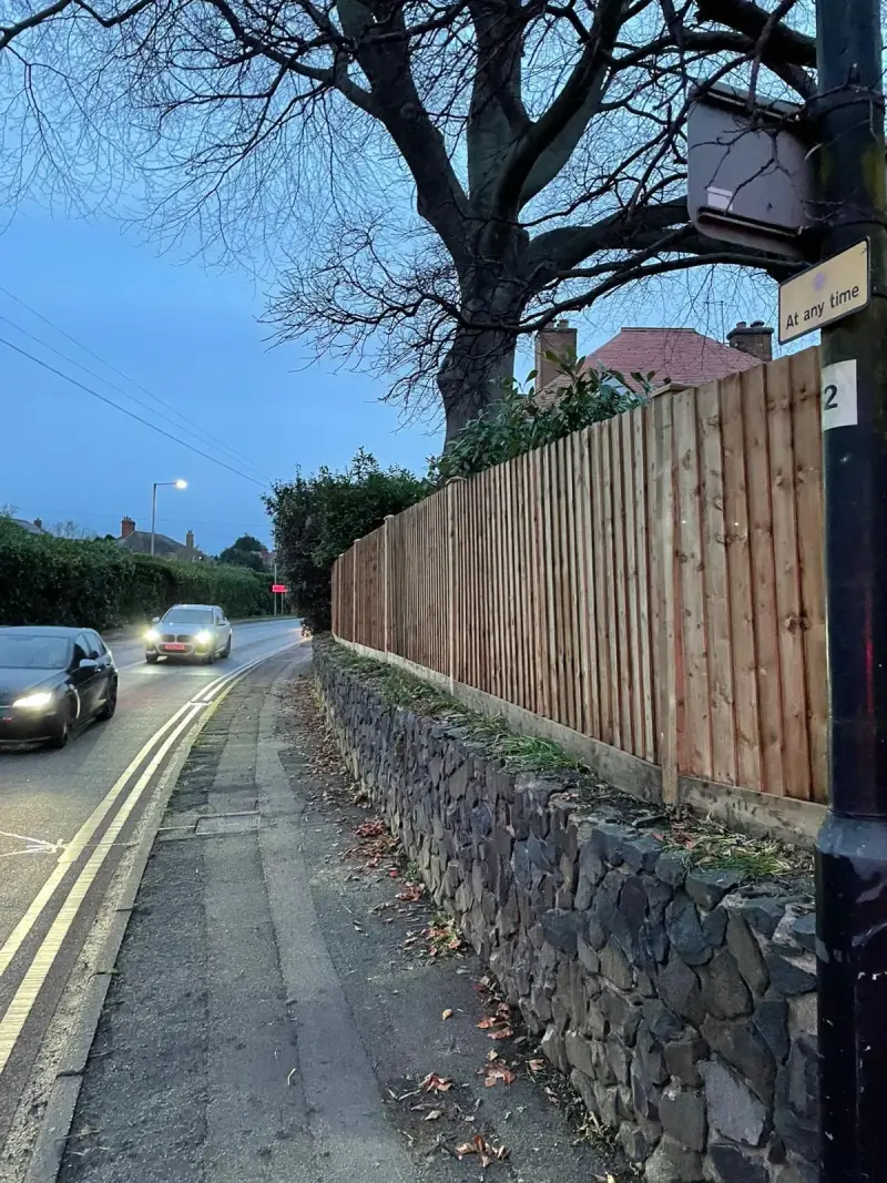 wooden fence built next to roadside