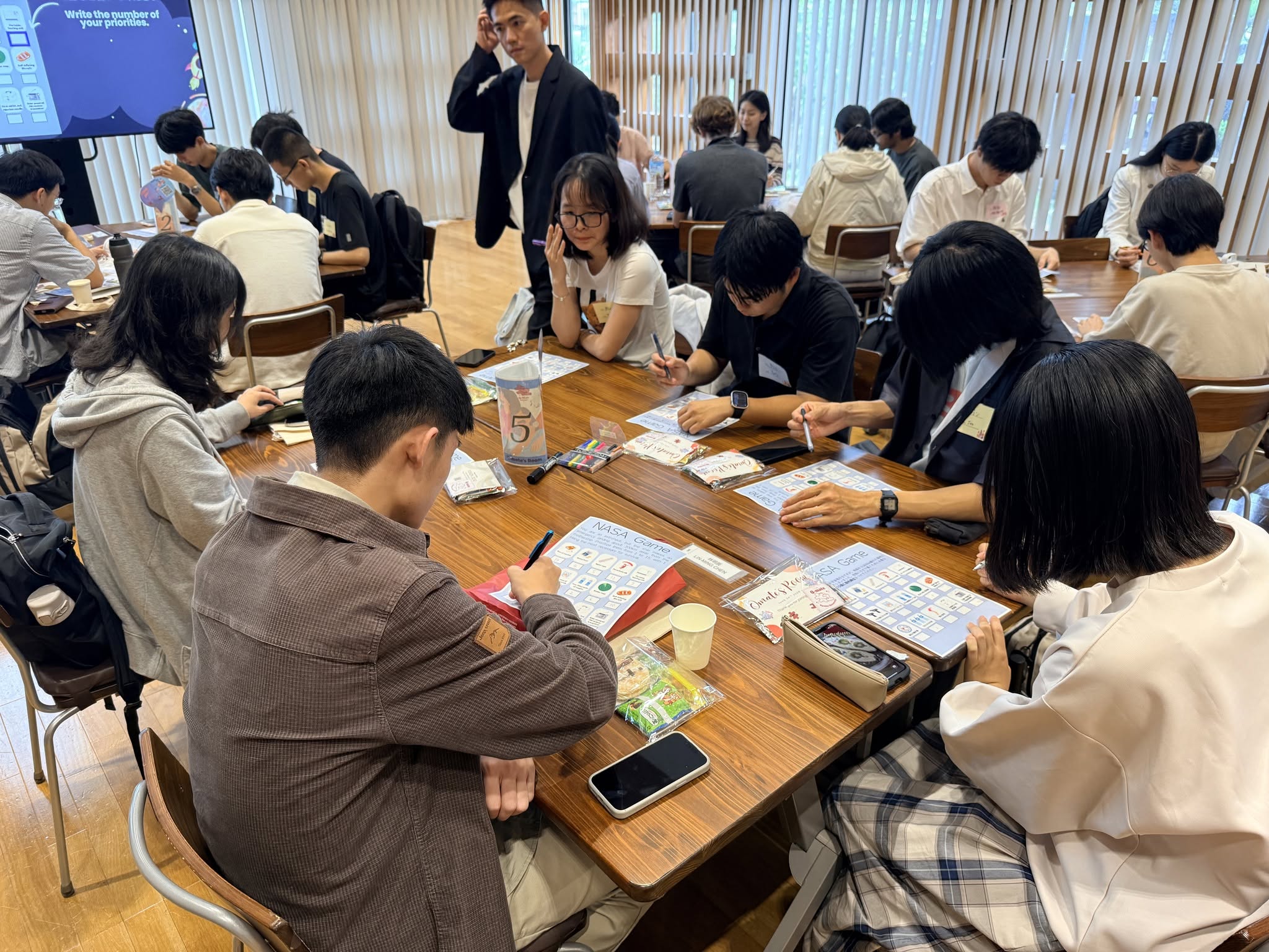 May be an image of one or more people, people studying, chess, children's toy and text