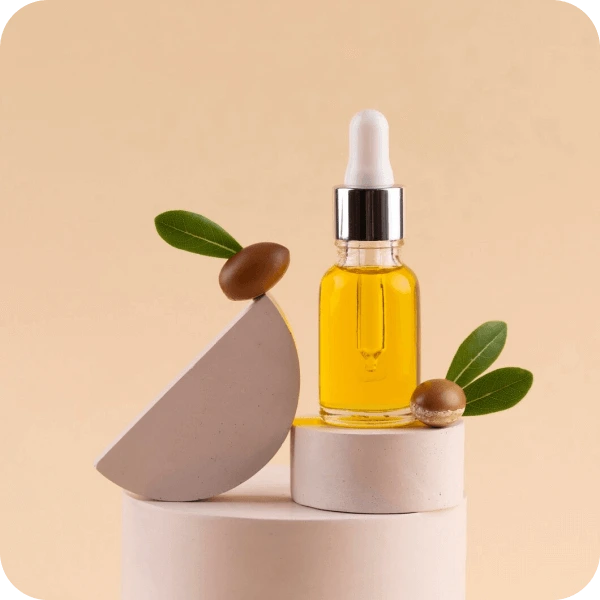 Beauty oil in a glass dropper with two olives