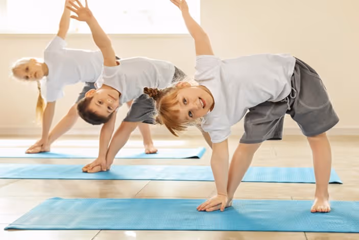 Three children doing yoga