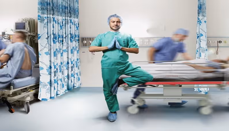 Doctor in yoga pose in hospital and patient being moved on bed