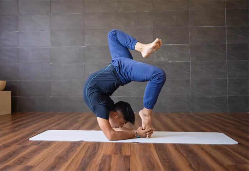 Yogi doing asana on mat