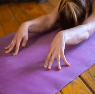 fingers stretched out on a yoga mat