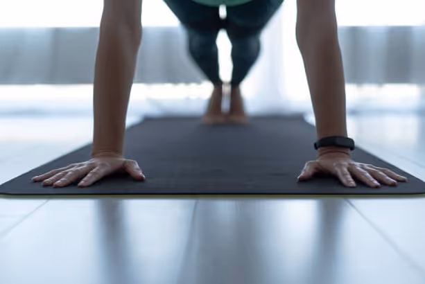 Hands and feet on the mat in plank position