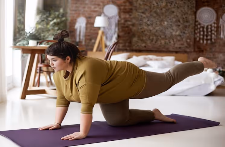 Fat yogi lady doing asana on mat