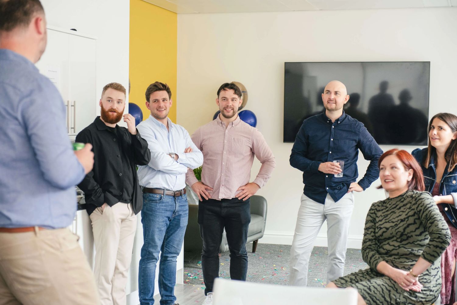 A group of people listening to a speech