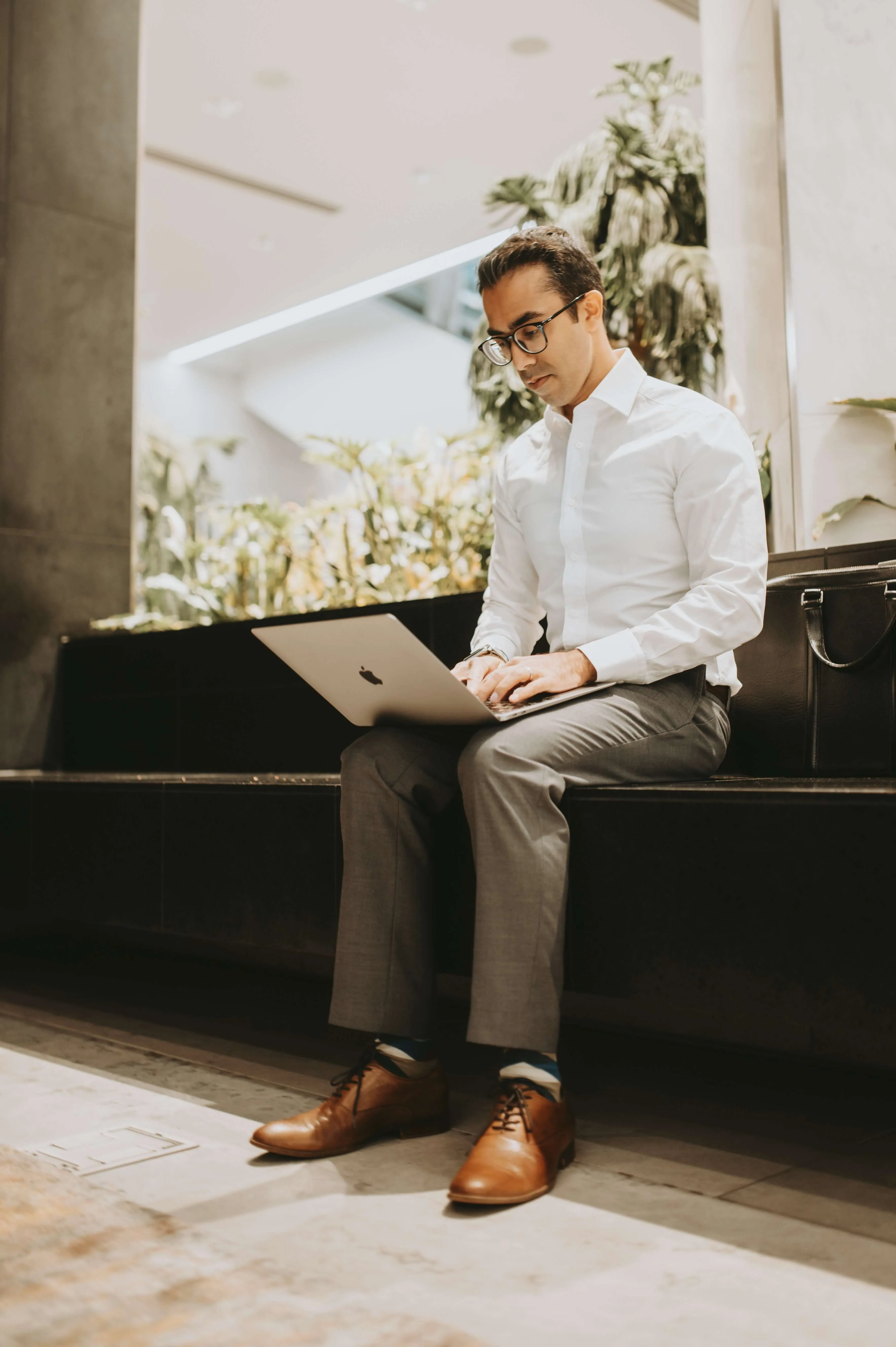 business man sitting down with laptop