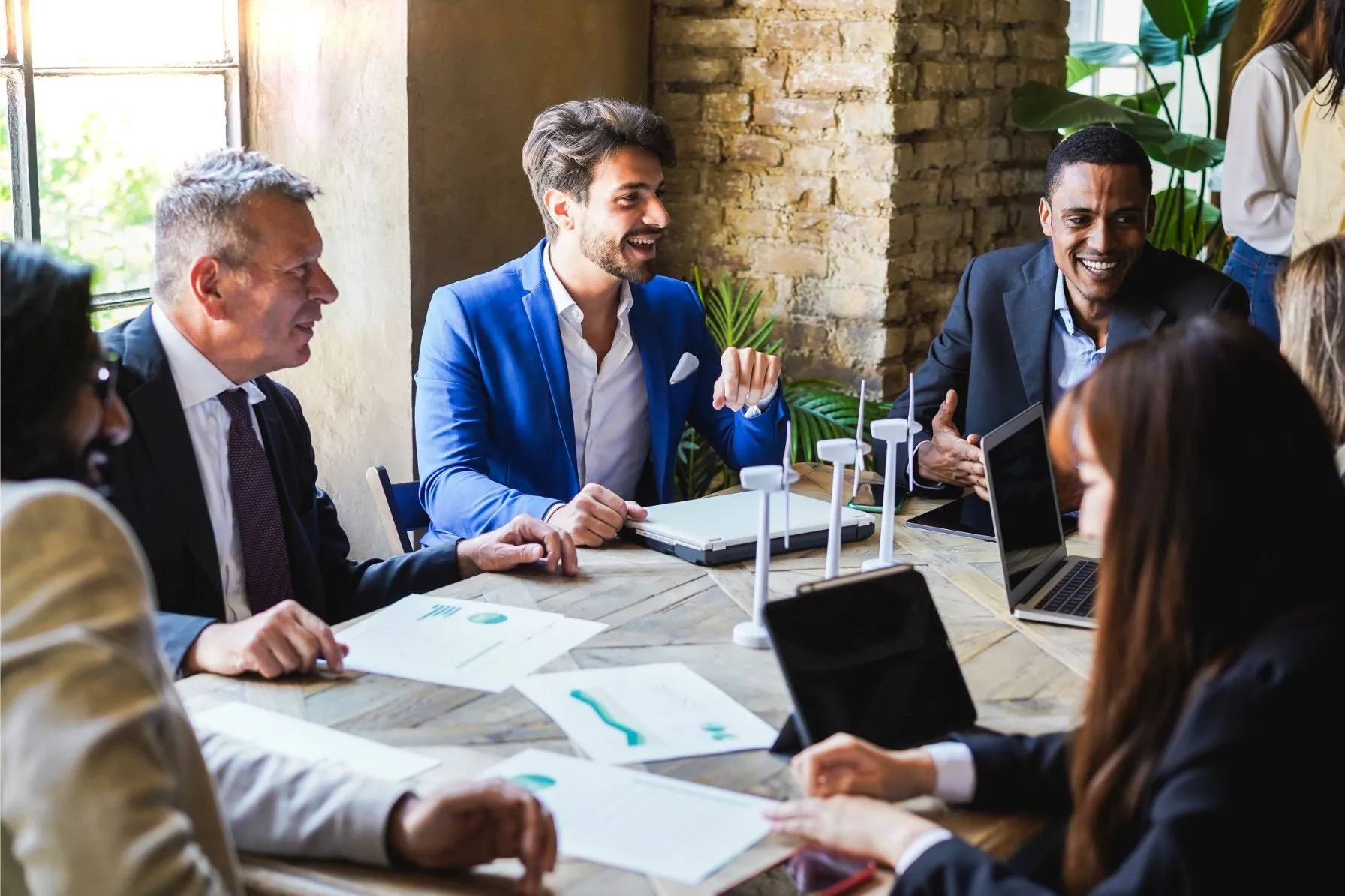 office people around a table chatting