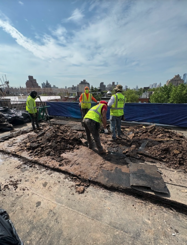 Crew working on the open roof deck near the skylight